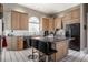 Gourmet kitchen features light wood cabinetry, tile backsplash, and a central island at 1591 Preston Trl, Carmel, IN 46032