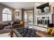 Spacious living room with fireplace, arched window, and comfortable leather seating at 1591 Preston Trl, Carmel, IN 46032