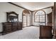 Bright main bedroom with light carpet, dark-wood dresser, and two large arched windows at 1591 Preston Trl, Carmel, IN 46032