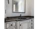 Stylish powder room features a granite countertop, and classic vanity at 1591 Preston Trl, Carmel, IN 46032