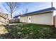 Backyard featuring a well-maintained lawn and a detached garage, perfect for outdoor activities at 1727 N New Jersey St # A, Indianapolis, IN 46202