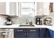 Modern kitchen with white quartz countertops, stainless steel appliances, and designer fixtures at 1727 N New Jersey St # A, Indianapolis, IN 46202
