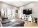 Comfortable living room with french doors, gray sofa and media center, providing a relaxing space at 1727 N New Jersey St # A, Indianapolis, IN 46202