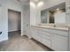 Elegant bathroom with double vanity, granite countertops, a large mirror, and tiled floors at 17877 Haralson Row, Westfield, IN 46074