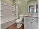 Bathroom with shower-tub, granite vanity, white fixtures and wood-look floors at 17877 Haralson Row, Westfield, IN 46074