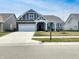 Inviting home exterior with a well-kept lawn and a convenient driveway leading to a spacious garage at 17877 Haralson Row, Westfield, IN 46074