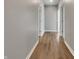 Long hallway with wood look flooring and multiple doorways at 17877 Haralson Row, Westfield, IN 46074