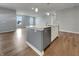 Kitchen island features white cabinets, stainless steel dishwasher, and stylish pendant lights at 17877 Haralson Row, Westfield, IN 46074
