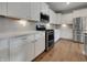 Modern kitchen boasts white cabinets, stainless steel appliances, granite countertops, and ample storage space at 17877 Haralson Row, Westfield, IN 46074