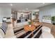 Open-concept living room showcasing hardwood floors, stylish furniture, and seamless flow into the kitchen at 17877 Haralson Row, Westfield, IN 46074