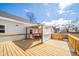 Spacious wooden back deck area with a shaded table and privacy screen, perfect for outdoor relaxation at 1815 Pearl St, Anderson, IN 46016