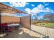 Back deck with partial covering, table, and a fire pit at 1815 Pearl St, Anderson, IN 46016