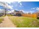 View of a backyard, fenced in yard with green grass and partial view of the back of the house at 1815 Pearl St, Anderson, IN 46016