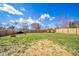 Large grassy backyard with wooden fence, providing a private space for recreation and enjoyment at 1815 Pearl St, Anderson, IN 46016