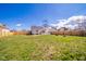 Expansive backyard featuring a well-maintained lawn and a wood fence, providing ample space for outdoor activities at 1815 Pearl St, Anderson, IN 46016