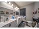Modern bathroom features double vanity sinks, ample lighting, and sleek fixtures at 1815 Pearl St, Anderson, IN 46016