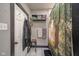 Practical bathroom with tiled shower, storage shelves, and well-maintained features at 1815 Pearl St, Anderson, IN 46016