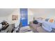 Small attic bedroom with seating area, desk, and plush carpet at 1815 Pearl St, Anderson, IN 46016