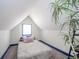 Small attic bedroom with a sloped ceiling, a twin bed and a plant at 1815 Pearl St, Anderson, IN 46016