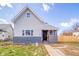 Charming two-story home with gray siding, black brick accents, and a quaint front yard at 1815 Pearl St, Anderson, IN 46016