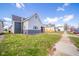 View of a two-story home with gray siding, showcasing its side yard and proximity to the street at 1815 Pearl St, Anderson, IN 46016