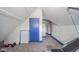 Attic gym with blue door, carpet, and angled ceilings at 1815 Pearl St, Anderson, IN 46016