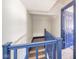 Hallway with blue railing for stairs leading to an open doorway at 1815 Pearl St, Anderson, IN 46016