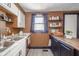 Cozy kitchen showcasing white cabinets and open wooden shelving for storage at 1815 Pearl St, Anderson, IN 46016