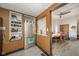 Open kitchen with stainless steel refrigerator and view into dining room at 1815 Pearl St, Anderson, IN 46016