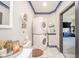 Bright laundry room with stacked washer and dryer next to toilet at 1815 Pearl St, Anderson, IN 46016