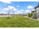 Landscaped backyard overlooking a pond, featuring a well-manicured lawn at 18271 Lake Winds Dr, Westfield, IN 46074