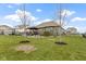 Spacious backyard showcasing lush greenery, trees, and a patio at 18271 Lake Winds Dr, Westfield, IN 46074