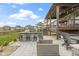 Backyard patio featuring stone outdoor kitchen, bar seating, and comfortable lounge chairs at 18271 Lake Winds Dr, Westfield, IN 46074