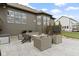 Outdoor patio with seating around a stone fire pit and an outdoor kitchen at 18271 Lake Winds Dr, Westfield, IN 46074
