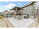 Backyard patio with outdoor seating around a stone fire pit and an outdoor kitchen at 18271 Lake Winds Dr, Westfield, IN 46074