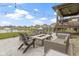 Beautiful backyard patio with stone fire pit, outdoor kitchen, and a view of the lake at 18271 Lake Winds Dr, Westfield, IN 46074