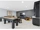 An entertainment-ready basement has a custom bar, a shuffleboard table, and a cozy seating area at 18271 Lake Winds Dr, Westfield, IN 46074