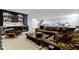 A modern finished basement offers a stylish bar area and a comfortable seating space with a large leather sofa at 18271 Lake Winds Dr, Westfield, IN 46074
