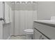 Cozy bathroom featuring a shower curtain, white towels, and grey cabinets at 18271 Lake Winds Dr, Westfield, IN 46074