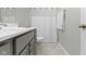 Bright bathroom features gray vanity, modern sink and shower with a white shower curtain at 18271 Lake Winds Dr, Westfield, IN 46074
