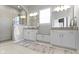 A bright bathroom boasts dual vanities, a tiled shower, and stylish fixtures for a luxurious feel at 18271 Lake Winds Dr, Westfield, IN 46074
