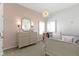 Charming bedroom featuring a pink accent wall, a mirror, and light-filled windows at 18271 Lake Winds Dr, Westfield, IN 46074