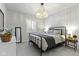 Bedroom featuring a modern chandelier, a black metal bed frame, and neutral color palette at 18271 Lake Winds Dr, Westfield, IN 46074