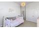 Bright bedroom with a white daybed, decorative artwork, and a unique sphere light fixture at 18271 Lake Winds Dr, Westfield, IN 46074