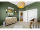 Bedroom with a changing table, decorative mirror, and easy access to a closet at 18271 Lake Winds Dr, Westfield, IN 46074