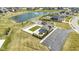 Aerial view of a community pool, playground, pond with fountain, and neighborhood homes on a sunny day at 18271 Lake Winds Dr, Westfield, IN 46074