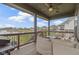 Relaxing covered patio featuring comfortable seating and scenic views of the serene lake at 18271 Lake Winds Dr, Westfield, IN 46074