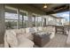 Comfortable covered porch with a large sectional, coffee table, and an outdoor grill at 18271 Lake Winds Dr, Westfield, IN 46074