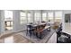 Bright dining area featuring large windows, a wooden table with bench, and stylish decor at 18271 Lake Winds Dr, Westfield, IN 46074