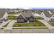 Single-Gathering home with professional landscaping, a well-kept yard, and a serene pond in the background at 18271 Lake Winds Dr, Westfield, IN 46074